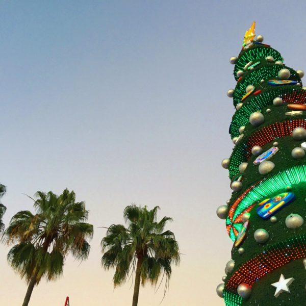 Mexico sky with palm trees and fake Christmas tree