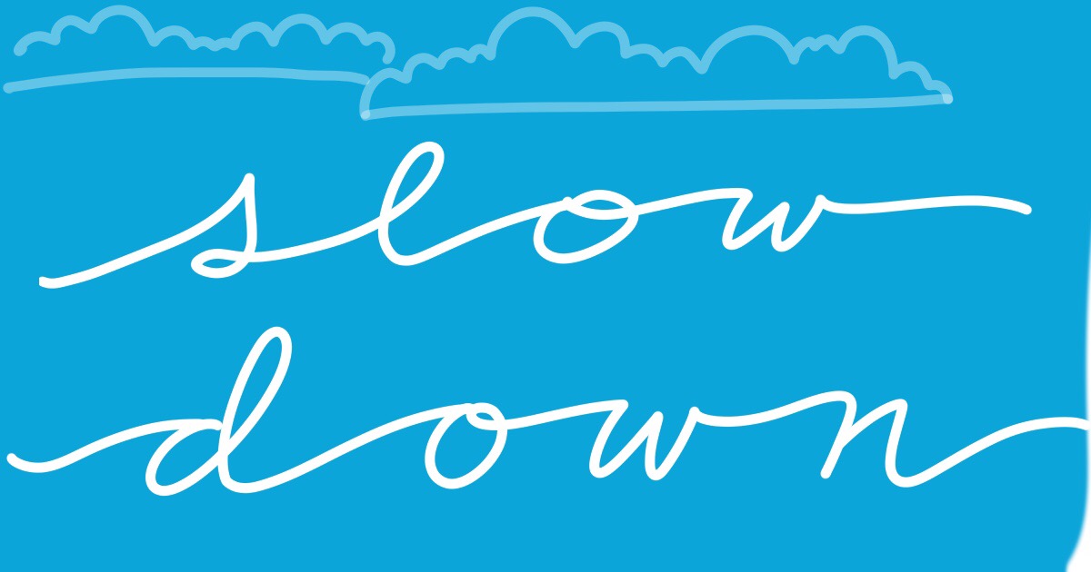 handwritten text on a vibrant coloured background: slow down