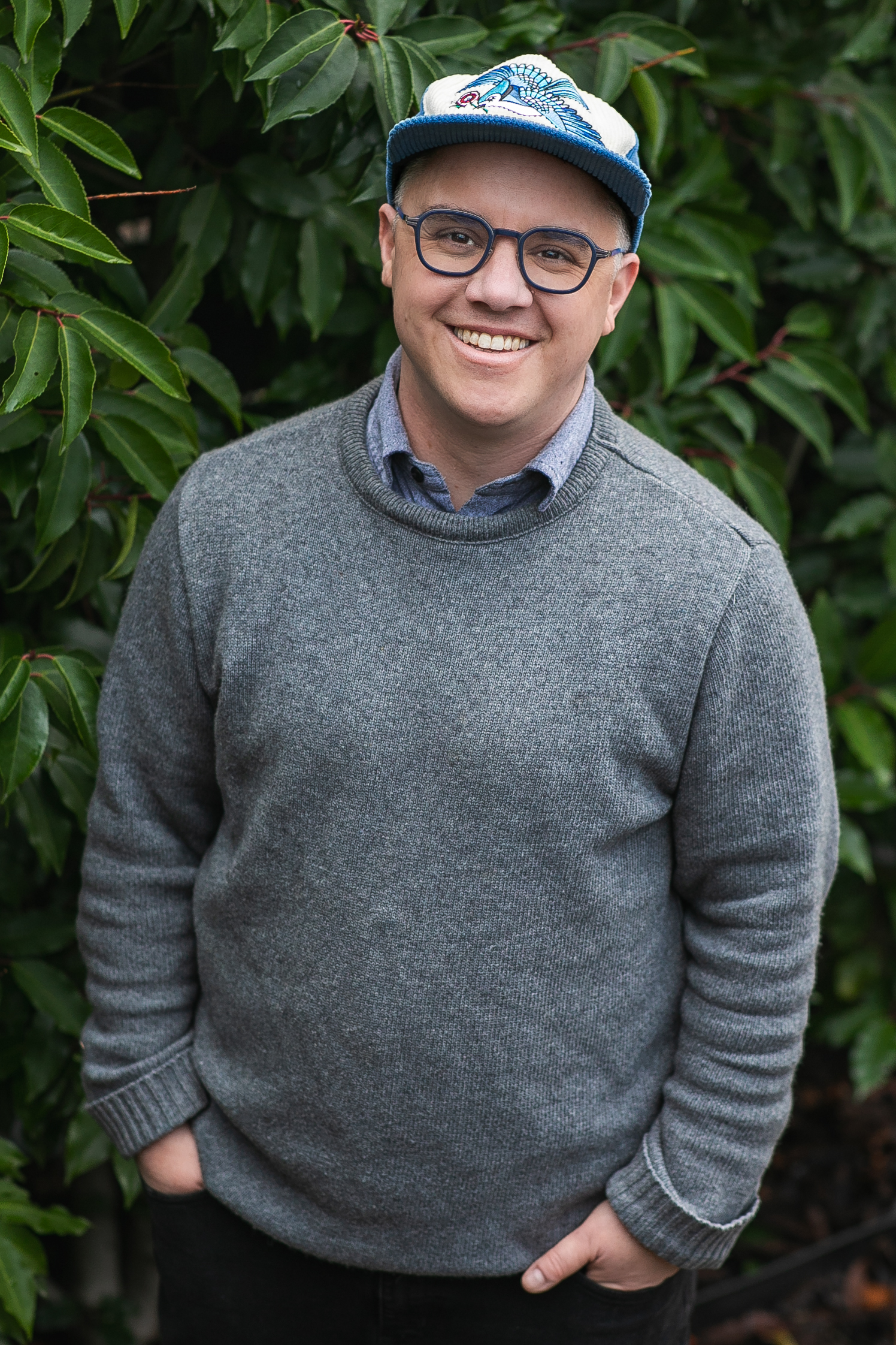 image of Sam Bradd  (he/him) standing up, mid-40s and of Italian-Scottish background